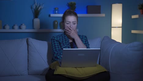 Woman-watching-movie-on-laptop-at-night.